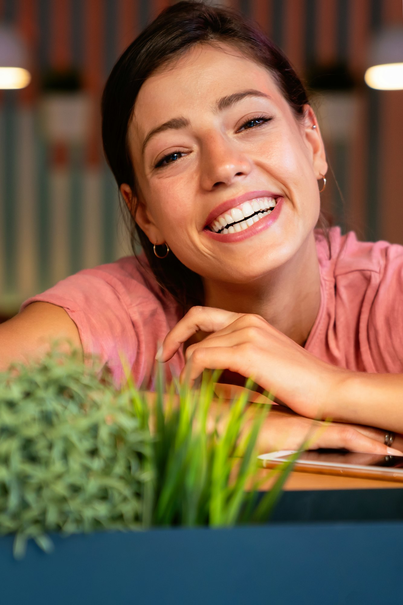 A woman with orthodontic treatments smiling