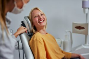 Female patient smiling in a dental chair at Twin Oaks Dental Studio during a CEREC® Same-Day Crowns appointment