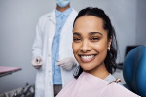 Woman smiling in a dental chair at Twin Oaks Dental Studio, showcasing the comfort and convenience of CEREC® Same-Day Crowns in Twin Oaks, MO.