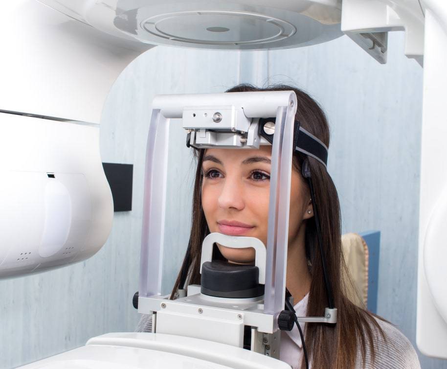 Female patient receiving a panoramic dental X-ray scan at a modern dental clinic in Valley Park Missouri