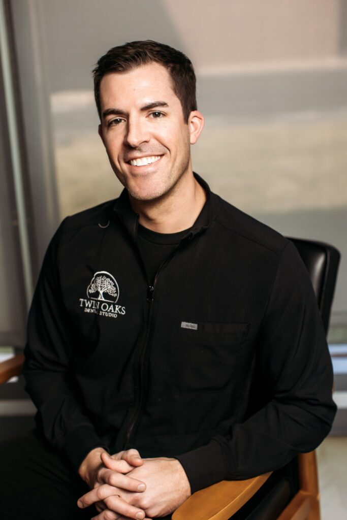 Male dentist from Twin Oaks Dental Studio smiling in a professional portrait at a Valley Park MO dental office