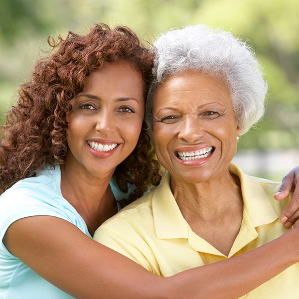 Mother and daughter smiling with healthy teeth after dental care in Valley Park MO