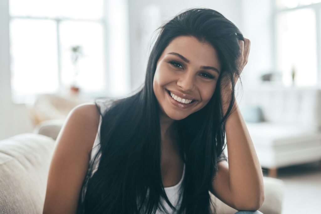 Happy female dental patient smiling during a visit to a dentist office in Valley Park Missouri