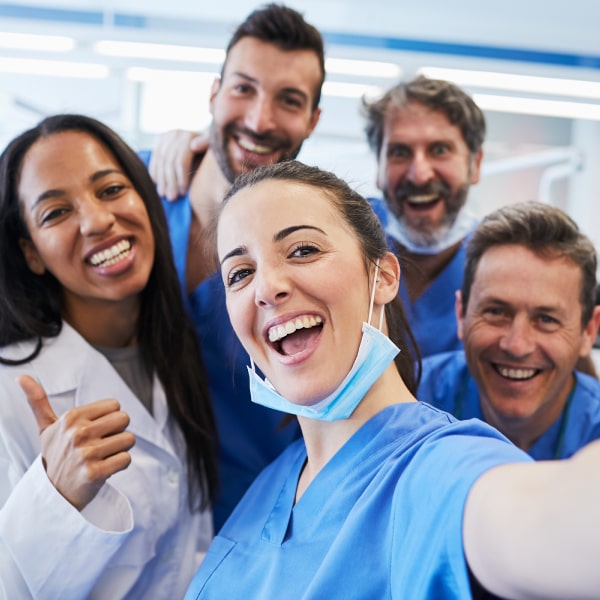 Friendly dental team taking a selfie inside a modern dental clinic in Valley Park MO